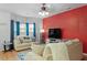 Spacious living room with a sofa, bright bay windows, and an accent wall at 300 Gilman Ln # 101, Raleigh, NC 27610