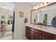 Elegant bathroom with double sinks, wood cabinets, and a large mirror at 3002 Bartlett Cir, Hillsborough, NC 27278