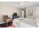 Comfortable bedroom with wood floors, wicker chair, and serene decor at 3002 Bartlett Cir, Hillsborough, NC 27278