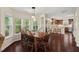 Open-concept dining area with hardwood floors, seamlessly connecting to the adjacent kitchen at 3002 Bartlett Cir, Hillsborough, NC 27278