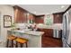 Beautiful kitchen with granite counters, wood cabinets, stainless steel appliances, and bar stool seating at 3002 Bartlett Cir, Hillsborough, NC 27278