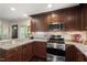 Updated kitchen features granite countertops, stainless steel appliances, and rich wood cabinetry at 3002 Bartlett Cir, Hillsborough, NC 27278