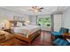 Cozy primary bedroom features a ceiling fan, recessed lighting, and backyard views at 3002 Bartlett Cir, Hillsborough, NC 27278