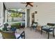 Relaxing screened-in patio with comfortable seating and a ceiling fan for outdoor enjoyment at 3002 Bartlett Cir, Hillsborough, NC 27278