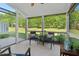 Charming screened porch with chairs, table, and serene backyard views at 3002 Bartlett Cir, Hillsborough, NC 27278