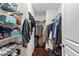 Organized walk-in closet with multiple shelves and hanging rods at 3002 Bartlett Cir, Hillsborough, NC 27278