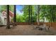 Secluded backyard features a fire pit, hammock, wooded views, and a classic privacy fence at 3016 Bolo Trl, Raleigh, NC 27615
