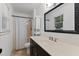 Clean bathroom features a dark vanity with a white countertop, a shower with a curtain, and an updated mirror at 3016 Bolo Trl, Raleigh, NC 27615
