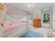 Charming bedroom boasts floral wallpaper, daybed with pink bedding, and natural light through windows at 3016 Bolo Trl, Raleigh, NC 27615