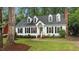 Charming two-story home with a well-manicured front yard, dormer windows, and black shutters at 3016 Bolo Trl, Raleigh, NC 27615