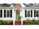 Inviting front porch with a wreath and an American flag welcomes you to this charming home at 3016 Bolo Trl, Raleigh, NC 27615