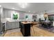 Open kitchen and dining area featuring modern gray cabinets and an island at 3016 Bolo Trl, Raleigh, NC 27615