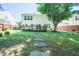 Spacious backyard with mature tree, patio, and a stone paver path at 3016 Hayling Dr, Raleigh, NC 27610