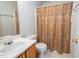 Bathroom featuring a neutral shower curtain, toilet, vanity and mirror at 3016 Hayling Dr, Raleigh, NC 27610