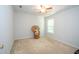 Cozy bedroom with neutral carpet, ceiling fan, and natural light from a window at 3016 Hayling Dr, Raleigh, NC 27610