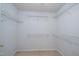 Walk-in closet with white shelving and neutral carpet at 3016 Hayling Dr, Raleigh, NC 27610