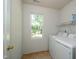 Laundry room with side-by-side washer and dryer and window at 3016 Hayling Dr, Raleigh, NC 27610
