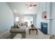 Cozy living room with fireplace, ceiling fan, and ample natural light at 3016 Hayling Dr, Raleigh, NC 27610