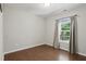 Cozy bedroom with hardwood floors, a window, and neutral wall color at 305 Old School Rd, Chapel Hill, NC 27516