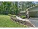 Exterior elevation with a view of the deck and screened-in porch surrounded by lush greenery at 305 Old School Rd, Chapel Hill, NC 27516