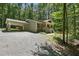 Charming home with a covered carport and welcoming red front door nestled in a lush, wooded setting at 305 Old School Rd, Chapel Hill, NC 27516