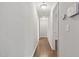 Bright hallway featuring hardwood floors and neutral paint, connecting various rooms in the home at 305 Old School Rd, Chapel Hill, NC 27516