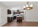 Modern kitchen with dark cabinets, granite countertops, stainless steel appliances, and a center island at 305 Old School Rd, Chapel Hill, NC 27516