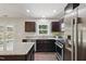 Well-equipped kitchen with dark wood cabinets, granite countertops, and stainless steel appliances at 305 Old School Rd, Chapel Hill, NC 27516