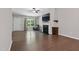 Open-concept living room with hardwood floors, fireplace, and a view to the front door at 305 Old School Rd, Chapel Hill, NC 27516
