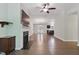 Hardwood floors in a well-lit open-concept living space with a fireplace and modern ceiling fan at 305 Old School Rd, Chapel Hill, NC 27516