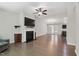 Spacious living room featuring hardwood floors, a fireplace, and a ceiling fan at 305 Old School Rd, Chapel Hill, NC 27516