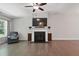 Bright living room with hardwood floors, a fireplace, and a comfortable armchair at 305 Old School Rd, Chapel Hill, NC 27516