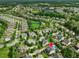 Beautiful aerial view of homes, neighborhood, community pool, and community park surrounded by lush greenery at 305 Springtree Circle Cir, Fuquay Varina, NC 27526