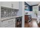 Bar area with a beverage refrigerator and granite countertops, perfect for entertaining at 305 Springtree Circle Cir, Fuquay Varina, NC 27526