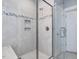 Glass enclosed shower stall with tile surround with a shower head and a small corner seat inside at 305 Springtree Circle Cir, Fuquay Varina, NC 27526