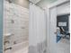This bathroom features a tub and shower with a marble tile surround and a sliding glass door entrance at 305 Springtree Circle Cir, Fuquay Varina, NC 27526