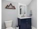Charming bathroom with stylish vanity, sink, decorative mirror, and a wood mountain wall decor at 305 Springtree Circle Cir, Fuquay Varina, NC 27526