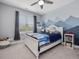 This bedroom has mountain mural and window with curtains, providing a cozy personal space at 305 Springtree Circle Cir, Fuquay Varina, NC 27526