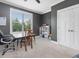 A bedroom painted in gray with a window for natural light, a closet, carpet, and a wooden chair at 305 Springtree Circle Cir, Fuquay Varina, NC 27526