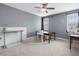 Spacious bedroom with carpeted floors, a ceiling fan, and ample natural light from the large windows at 305 Springtree Circle Cir, Fuquay Varina, NC 27526