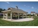 Covered seating area with picnic tables, outdoor grill, and a view of the landscaped grounds at 305 Springtree Circle Cir, Fuquay Varina, NC 27526