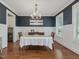 Formal dining room with wainscoting, elegant chandelier, and hardwood floors at 305 Springtree Circle Cir, Fuquay Varina, NC 27526