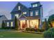 Charming two-story home featuring a welcoming front porch, a well-manicured lawn, and tasteful landscaping at 305 Springtree Circle Cir, Fuquay Varina, NC 27526