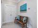 Hallway featuring a sitting bench with decorative pillows, white double doors and a landscape painting at 305 Springtree Circle Cir, Fuquay Varina, NC 27526