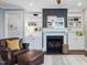 Cozy living room featuring a fireplace, built-in bookshelves, and a comfortable armchair at 305 Springtree Circle Cir, Fuquay Varina, NC 27526