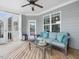 Inviting screened porch with ceiling fan, comfortable seating and an entry door to the home's interior at 305 Springtree Circle Cir, Fuquay Varina, NC 27526