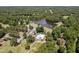 Bird's-eye view of a community featuring a lake, pool, tennis courts, and golf course amidst verdant forests at 307 Country Club Dr, Durham, NC 27712