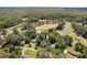 High angle image of a residential area with private golf course surrounded by green canopy of mature trees at 307 Country Club Dr, Durham, NC 27712