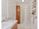 Bathroom features a shower with glass door, built-in shelves, and ample cabinet space at 307 Country Club Dr, Durham, NC 27712