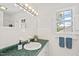 Bathroom with a green countertop, white tile, and a window with shutters at 307 Country Club Dr, Durham, NC 27712